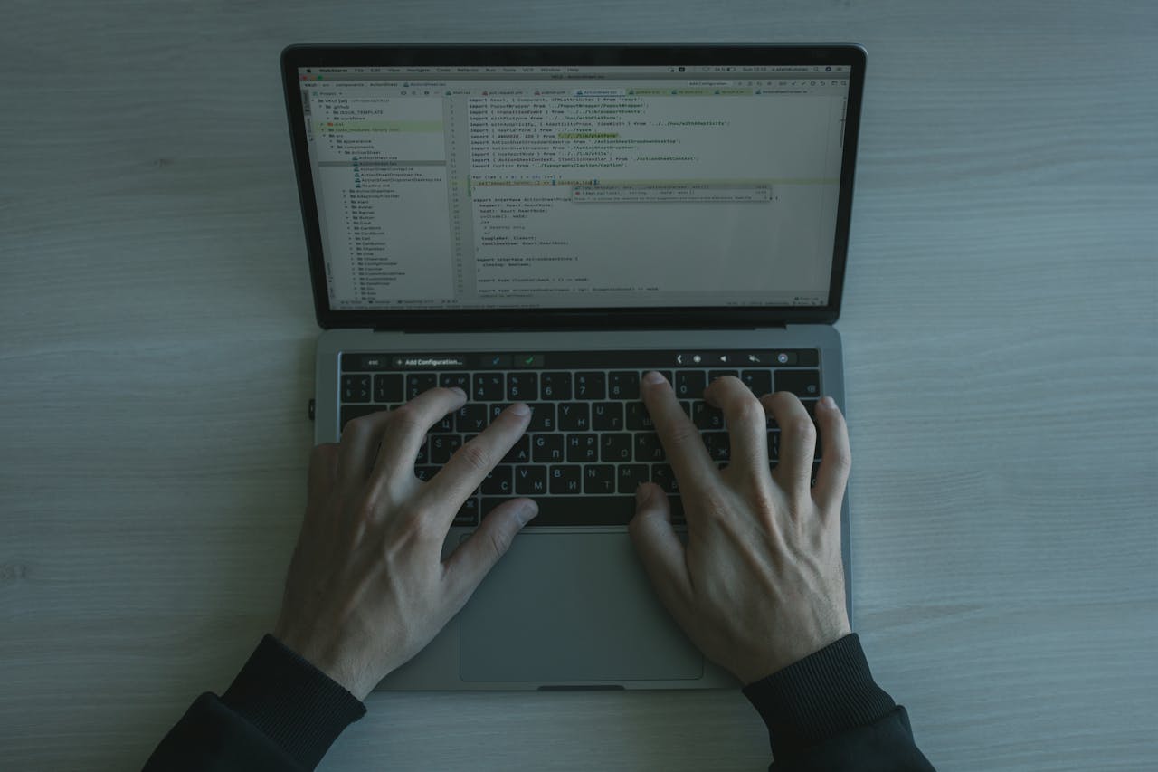 Hands Typing on a Laptop Keyboard